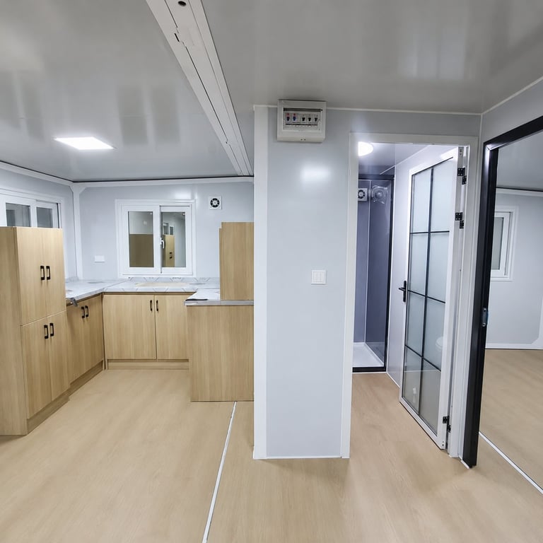 Modern interior space with light wood cabinetry, white walls, and hallway with black framed doors